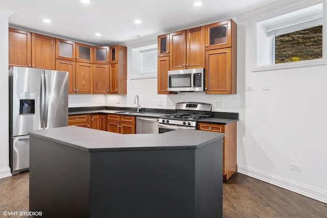 506 W Oakdale Ave Unit 1, Chicago, IL 60657 - kitchen with stainless steel appliances, brown cabinetry, dark wood-style floors, backsplash, and recessed lighting