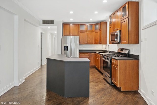 506 W Oakdale Ave Unit 1, Chicago, IL 60657 - kitchen featuring stainless steel appliances, brown cabinetry, backsplash, dark countertops, and a kitchen island