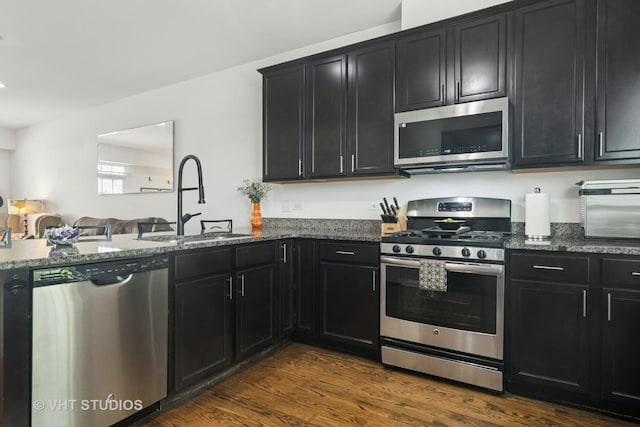 1527 E Arbor Ln, Arlington Heights, IL 60004 - kitchen with stainless steel appliances, dark cabinets, dark stone counters, and dark wood finished floors
