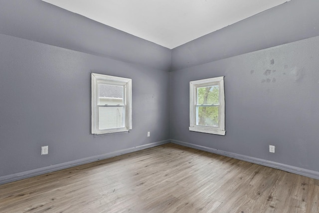 1121 Blaisdell St, Rockford, IL 61101 - spare room with wood finished floors and vaulted ceiling
