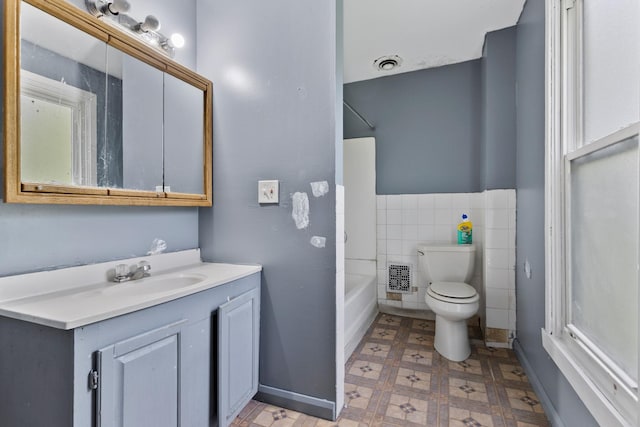 1121 Blaisdell St, Rockford, IL 61101 - full bath with vanity, tile walls, tile patterned floors, and shower / bathtub combination
