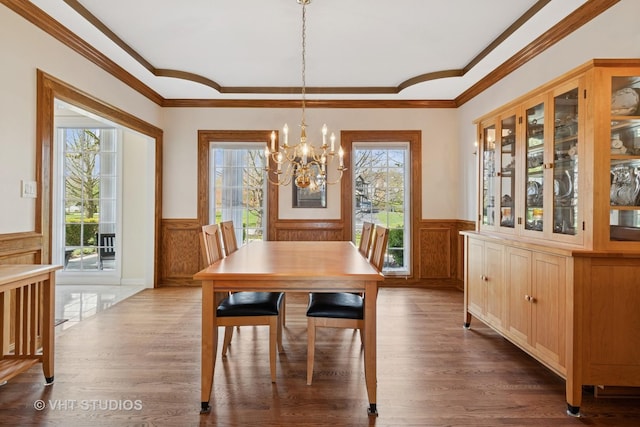 10603 Royal Porthcawl Dr, Naperville, IL 60564 - dining room featuring a wainscoted wall, ornamental molding, a chandelier, wood finished floors, and a decorative wall