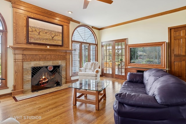 10603 Royal Porthcawl Dr, Naperville, IL 60564 - living room featuring crown molding, a ceiling fan, light wood-style flooring, a fireplace, and french doors