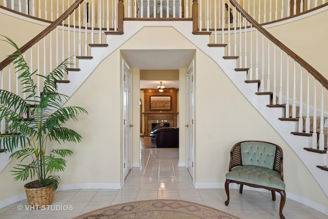 10603 Royal Porthcawl Dr, Naperville, IL 60564 - entryway featuring stairs, a fireplace, a towering ceiling, and tile patterned floors