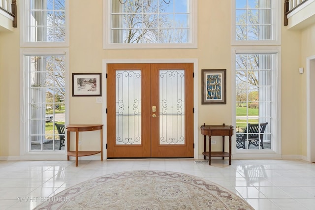 10603 Royal Porthcawl Dr, Naperville, IL 60564 - tiled entryway featuring a high ceiling, plenty of natural light, and french doors