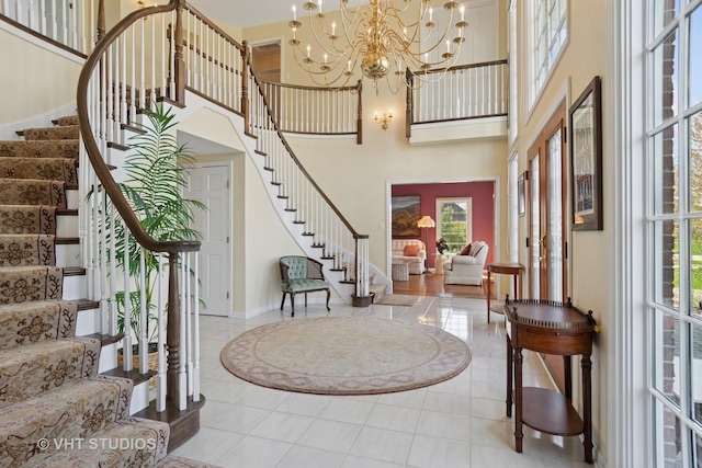 10603 Royal Porthcawl Dr, Naperville, IL 60564 - foyer featuring stairway, a high ceiling, a chandelier, and tile patterned floors