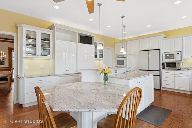 10603 Royal Porthcawl Dr, Naperville, IL 60564 - kitchen featuring white appliances, a kitchen island, a ceiling fan, dark wood-type flooring, and recessed lighting