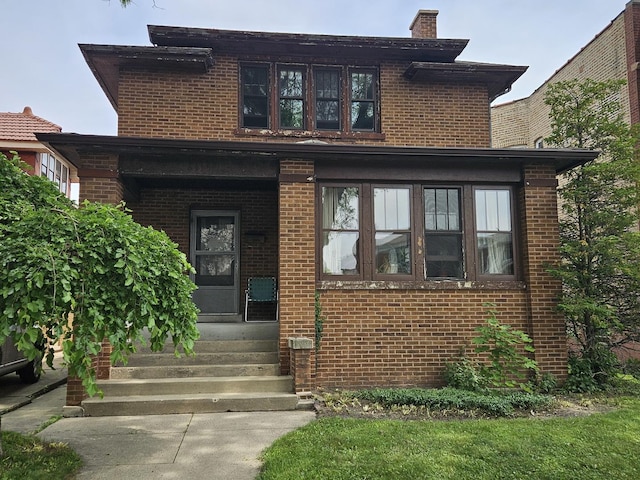 6515 N Maplewood Ave, Chicago, IL 60645 - traditional style home with brick siding, a chimney, and entry steps