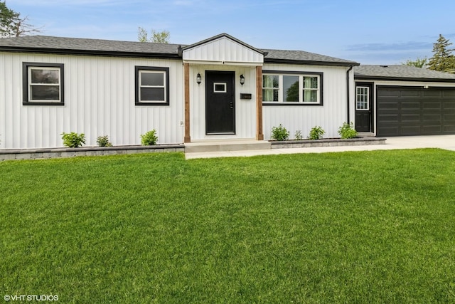 407 S York Rd, Bensenville, IL 60106 - view of front facade with a front yard, an attached garage, concrete driveway, and a shingled roof
