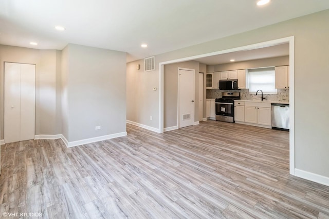407 S York Rd, Bensenville, IL 60106 - unfurnished living room with light wood-style floors and recessed lighting