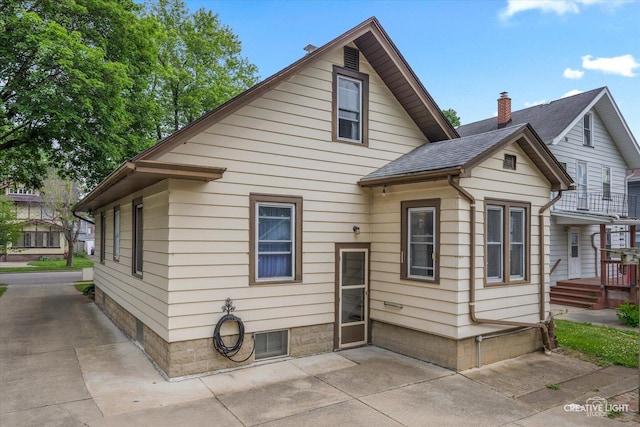 613 Jackson St, Aurora, IL 60505 - back of house featuring roof with shingles and a patio area