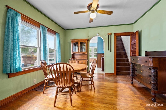 613 Jackson St, Aurora, IL 60505 - dining room featuring wood finished floors, healthy amount of natural light, stairway, a ceiling fan, and crown molding