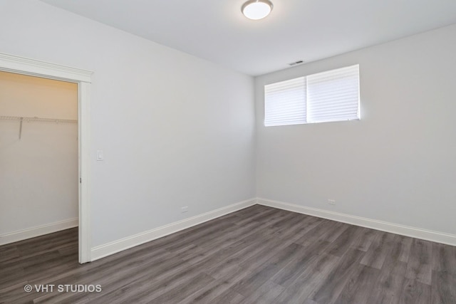 4714 W Berteau Ave Unit 1N, Chicago, IL 60641 - unfurnished bedroom featuring dark wood finished floors, a closet, and a walk in closet