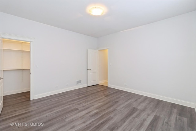 4714 W Berteau Ave Unit 1N, Chicago, IL 60641 - unfurnished bedroom featuring wood finished floors, a closet, and a spacious closet