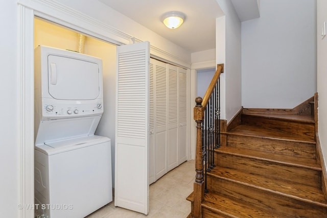 4714 W Berteau Ave Unit 1N, Chicago, IL 60641 - laundry room with stacked washer / dryer and light tile patterned floors