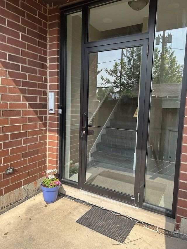 4714 W Berteau Ave Unit 1N, Chicago, IL 60641 - doorway to property with brick siding
