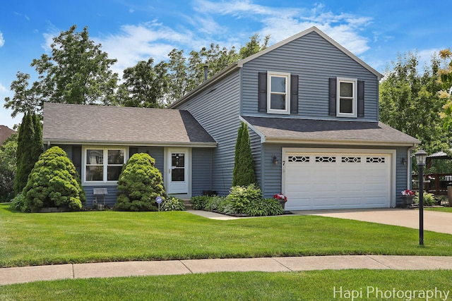 7 Kensington Ct, Streamwood, IL 60107 - view of front of home featuring a garage, concrete driveway, a front lawn, and roof with shingles