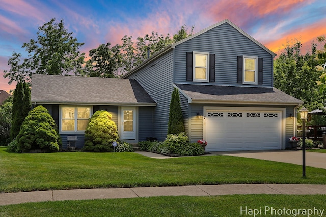 7 Kensington Ct, Streamwood, IL 60107 - view of front facade featuring a garage, driveway, a lawn, and a shingled roof