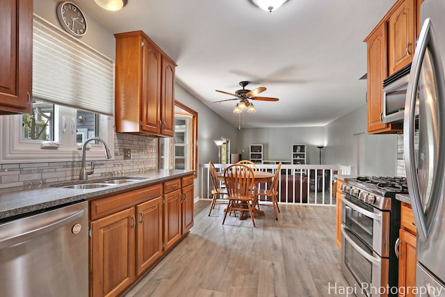 7 Kensington Ct, Streamwood, IL 60107 - kitchen with appliances with stainless steel finishes, tasteful backsplash, a ceiling fan, light wood-style floors, and brown cabinets