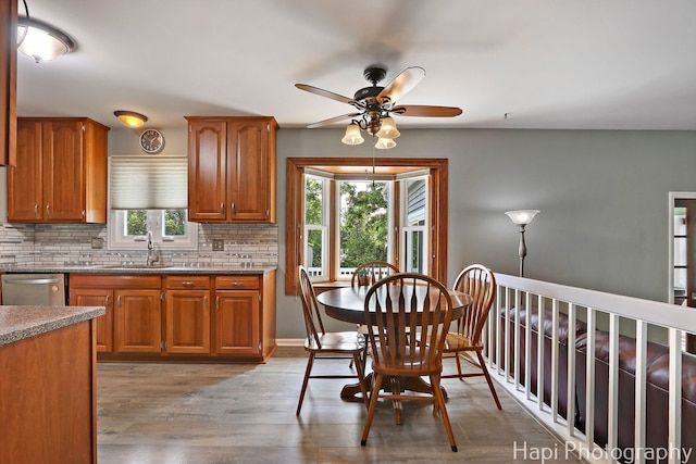 7 Kensington Ct, Streamwood, IL 60107 - kitchen with plenty of natural light, stainless steel dishwasher, a ceiling fan, and tasteful backsplash