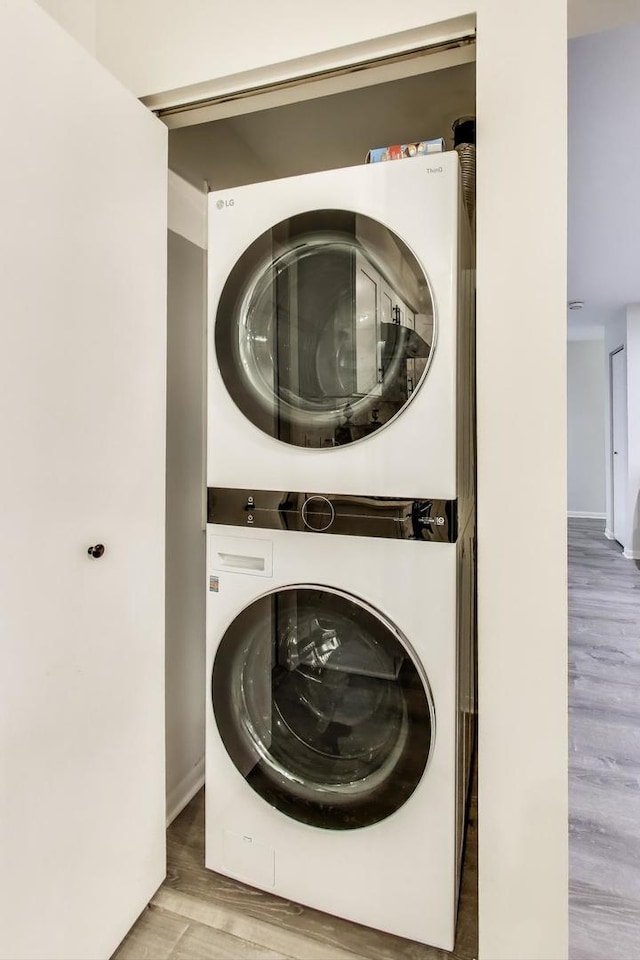 206 Country Ln, Des Plaines, IL 60016 - laundry area with stacked washer and clothes dryer and light wood finished floors