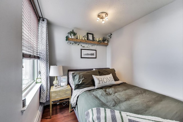 3033 N Sheridan Rd Unit 602, Chicago, IL 60657 - bedroom with wood finished floors and a baseboard heating unit