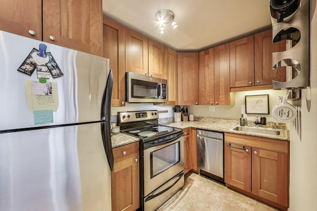 3033 N Sheridan Rd Unit 602, Chicago, IL 60657 - kitchen featuring stainless steel appliances, light tile patterned floors, light stone countertops, and brown cabinetry