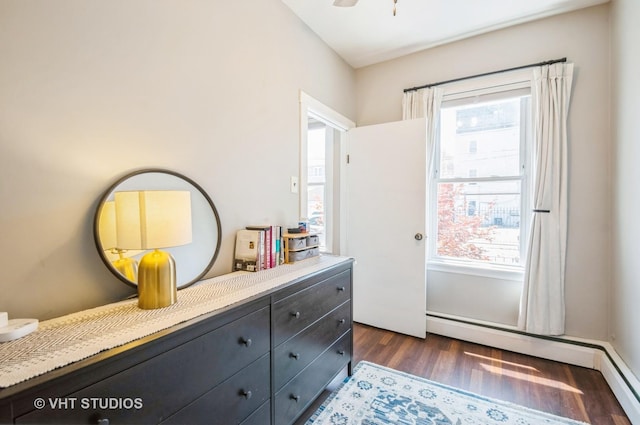 2835 S Farrell St, Chicago, IL 60608 - bedroom with dark wood-type flooring, multiple windows, and a baseboard heating unit