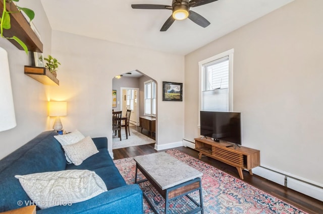 2835 S Farrell St, Chicago, IL 60608 - living area featuring arched walkways, a baseboard heating unit, wood finished floors, and a ceiling fan