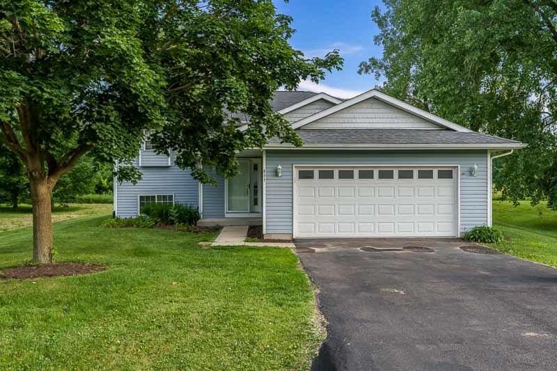 411 Benedict Dr SW, Poplar Grove, IL 61065 - view of front of house featuring driveway, a front lawn, an attached garage, and roof with shingles