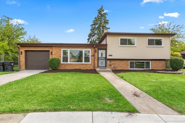 16211 Joyce Cir, South Holland, IL 60473 - tri-level home with an attached garage, a front lawn, driveway, brick siding, and a chimney