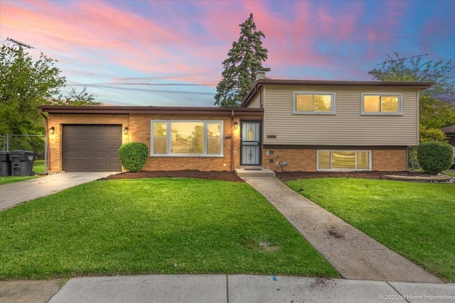 16211 Joyce Cir, South Holland, IL 60473 - tri-level home featuring an attached garage, driveway, and brick siding