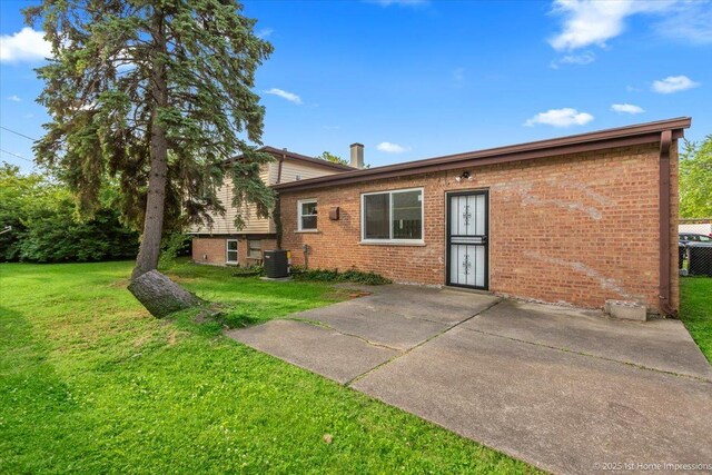 16211 Joyce Cir, South Holland, IL 60473 - back of property featuring brick siding, a patio, and a lawn