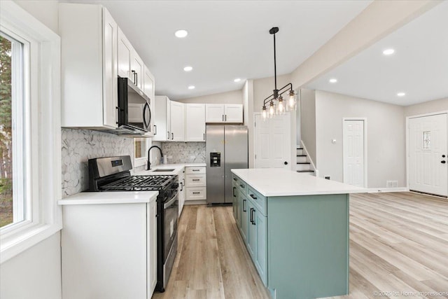 16211 Joyce Cir, South Holland, IL 60473 - kitchen with stainless steel appliances, decorative backsplash, a center island, light wood-style flooring, and light countertops