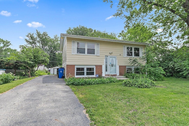 1011 Mark St, South Elgin, IL 60177 - raised ranch with a front lawn, brick siding, and asphalt driveway