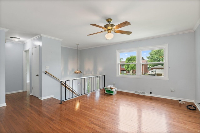 1011 Mark St, South Elgin, IL 60177 - empty room featuring wood-type flooring, ornamental molding, and ceiling fan