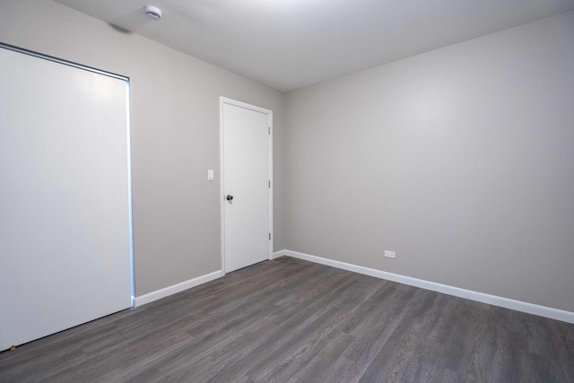 1745 N 40th Ave, Stone Park, IL 60165 - unfurnished bedroom featuring dark wood-style flooring and a closet