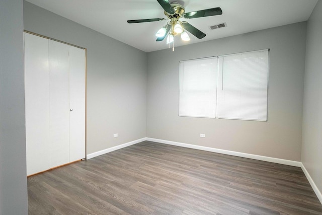 1745 N 40th Ave, Stone Park, IL 60165 - unfurnished bedroom featuring wood finished floors, a closet, and a ceiling fan