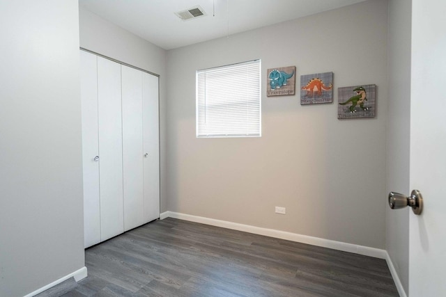 1745 N 40th Ave, Stone Park, IL 60165 - unfurnished bedroom with dark wood-type flooring and a closet