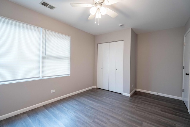 1745 N 40th Ave, Stone Park, IL 60165 - unfurnished bedroom featuring dark wood-style floors, a closet, and a ceiling fan