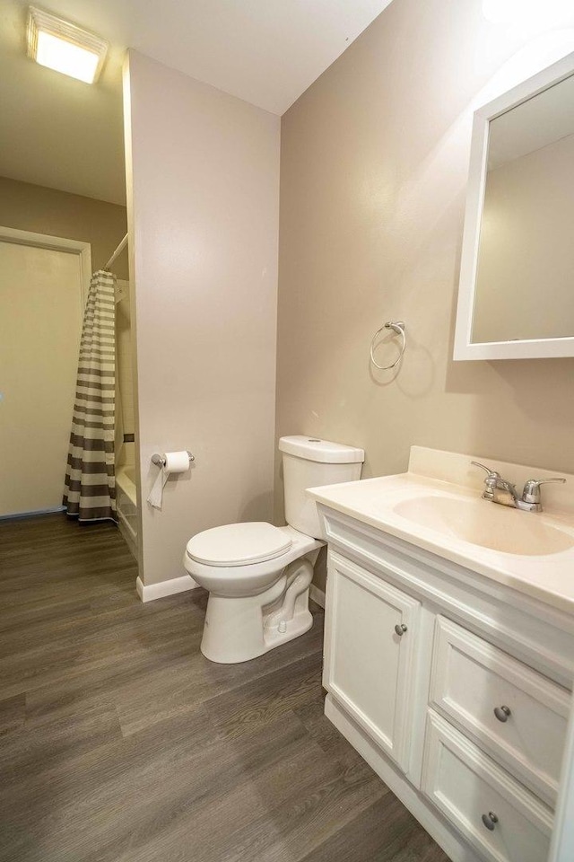 1745 N 40th Ave, Stone Park, IL 60165 - bathroom with wood finished floors, vanity, and shower / bath combo with shower curtain