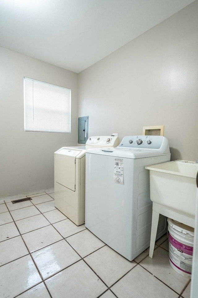 1745 N 40th Ave, Stone Park, IL 60165 - washroom featuring washing machine and dryer, light tile patterned flooring, and electric panel