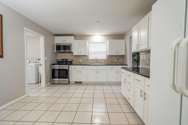 1745 N 40th Ave, Stone Park, IL 60165 - kitchen with appliances with stainless steel finishes, decorative backsplash, light tile patterned floors, and white cabinetry