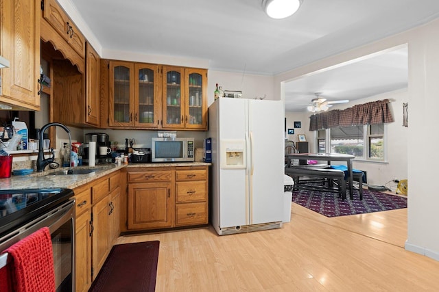 1508 N River Rd, Mchenry, IL 60051 - kitchen with stainless steel appliances, brown cabinets, and light wood-style floors