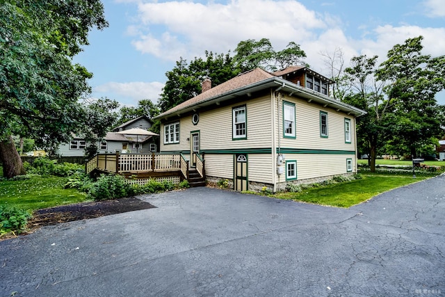 14723 Kildare Ave, Midlothian, IL 60445 - view of front facade with a deck, a chimney, and a front lawn