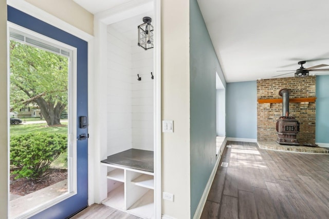 1888 Irene Rd, Sandwich, IL 60548 - mudroom featuring wood finished floors, a wood stove, and a ceiling fan