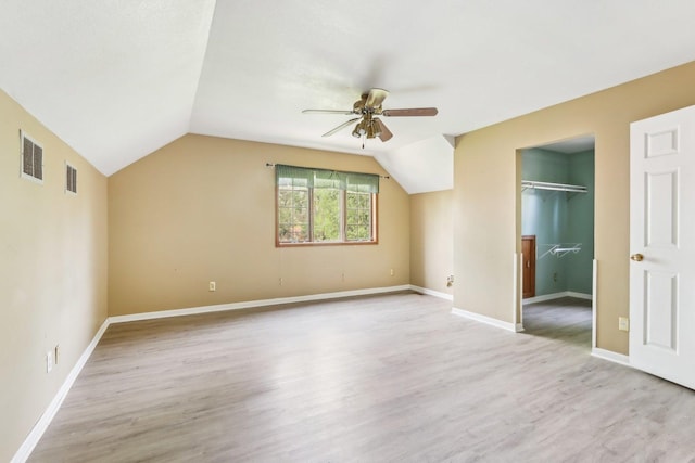 1888 Irene Rd, Sandwich, IL 60548 - unfurnished bedroom featuring a walk in closet, lofted ceiling, light wood-style flooring, a closet, and ceiling fan