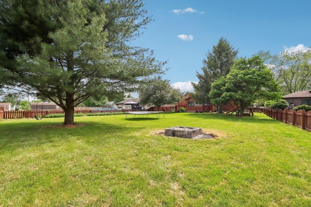 1888 Irene Rd, Sandwich, IL 60548 - fenced backyard featuring a trampoline and a fire pit