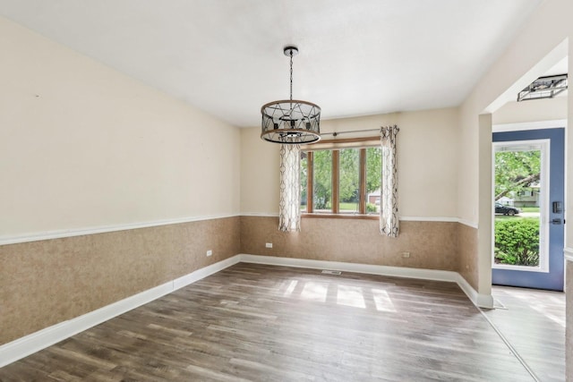 1888 Irene Rd, Sandwich, IL 60548 - unfurnished dining area featuring a chandelier, wood finished floors, and a wainscoted wall