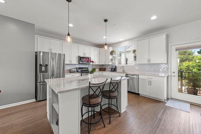 6308 Main St, Woodridge, IL 60517 - kitchen with appliances with stainless steel finishes, open shelves, a center island, white cabinetry, and decorative backsplash